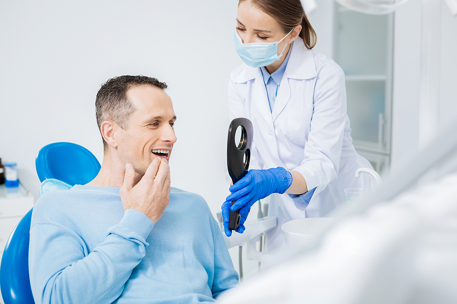 A patient wearing traditional braces at Spy Hill Dental Clinic.